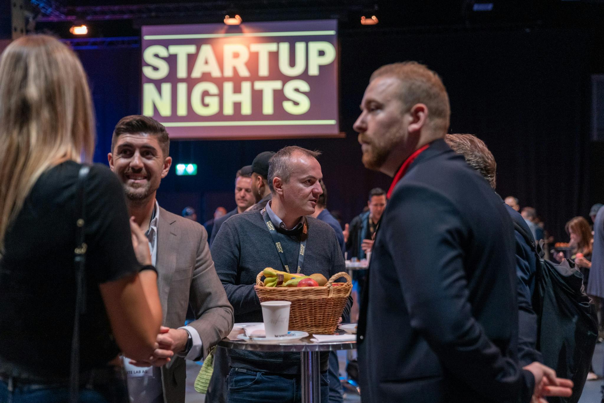 Attendees speaking together at Startup Nights