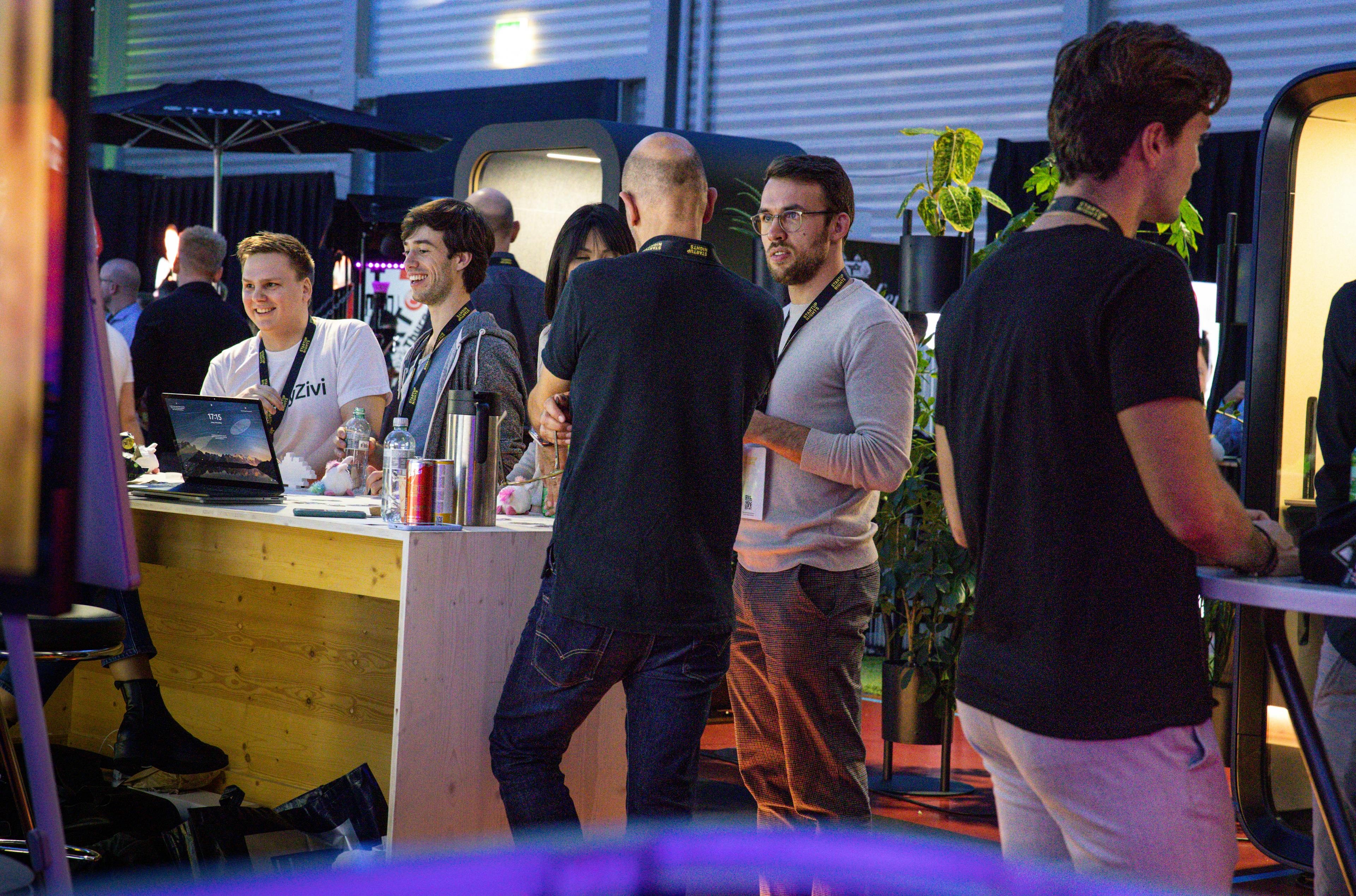Attendees at a startup booth